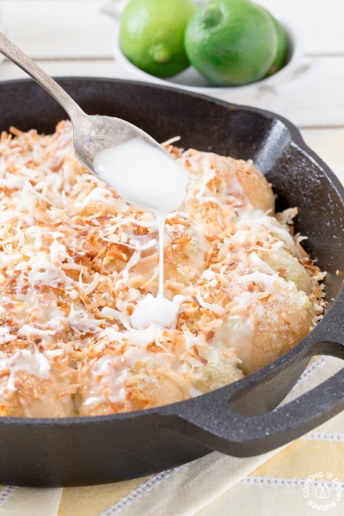 pouring glaze on lime coconut skillet rolls