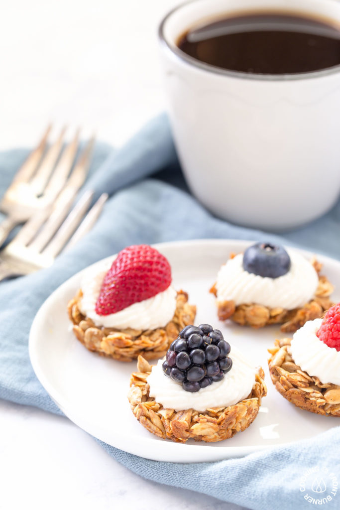 coffee with berry tarts on a plate