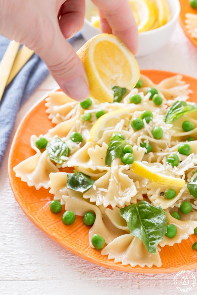 squeezing fresh lemon on a salad