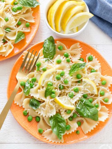You will love how light and tasty this Springy Lemon Bow Tie Salad is with tender peas, fresh basil, bow tie shaped pasta, tangy parmesan cheese and spritzed with freshly squeezed lemon juice and tossed in olive oil.  It makes a great dish to any meal and can be whipped up in no time!