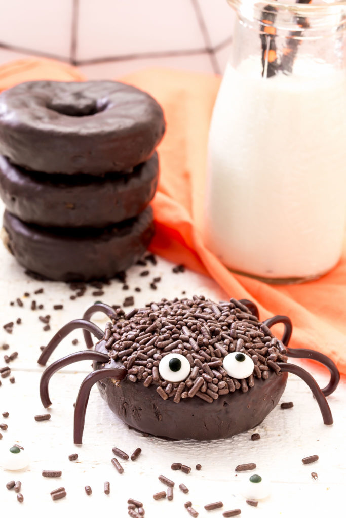 Chocolate spider donut with a glass of milk