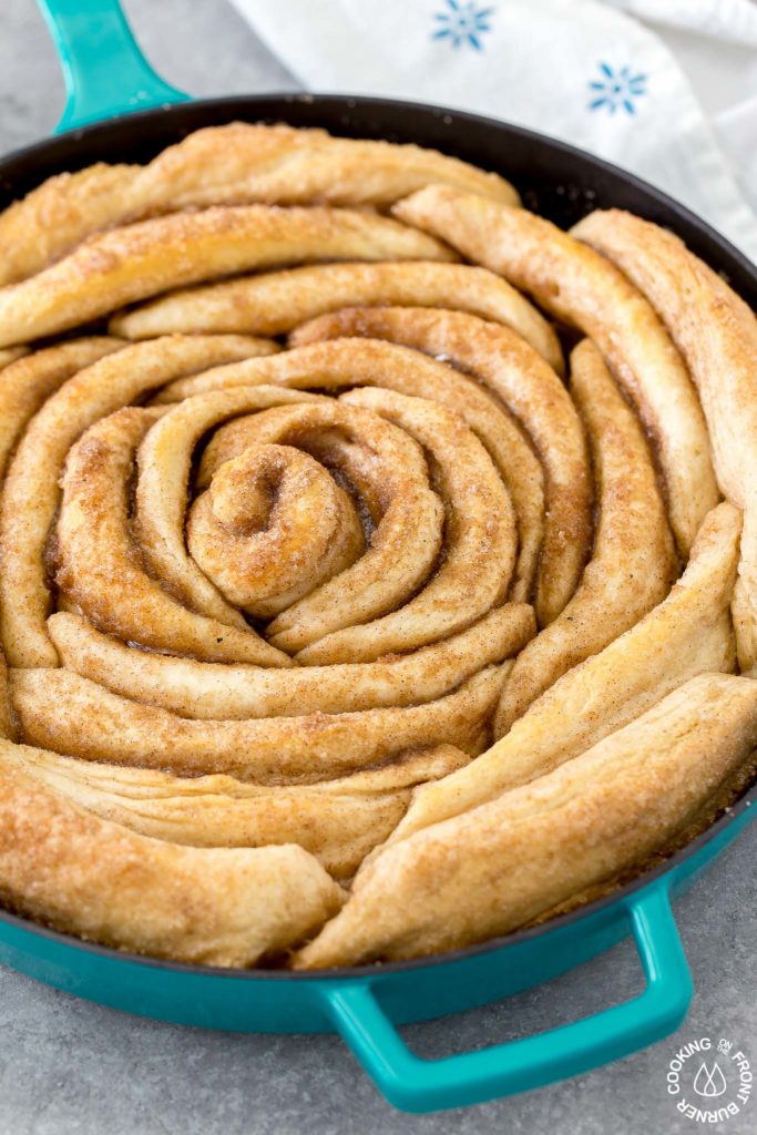 refrigerated biscuits in a skillet with pumpkin spice mixture