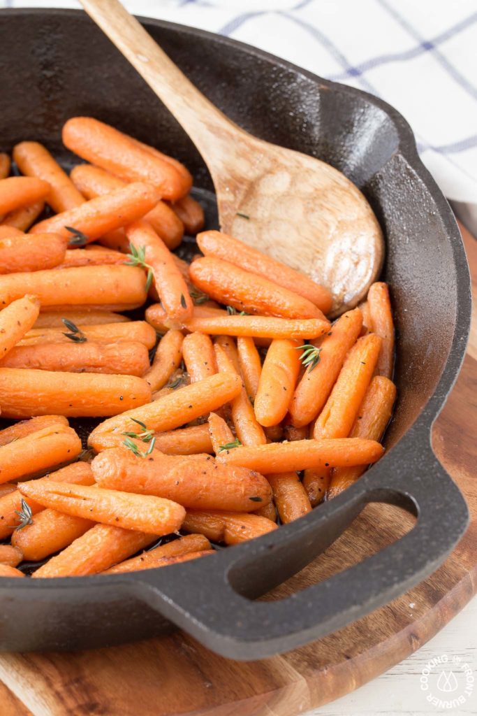 cast iron skillet with carrots on a trivet