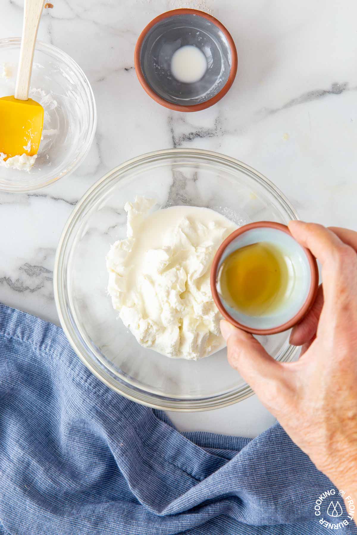 a bowl with goat cheese and adding honey