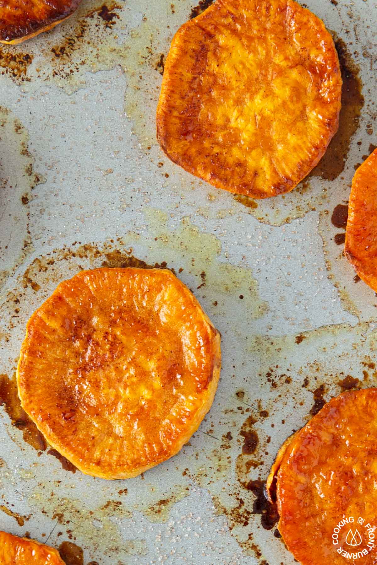a cookie sheet with baked sweet potato rounds