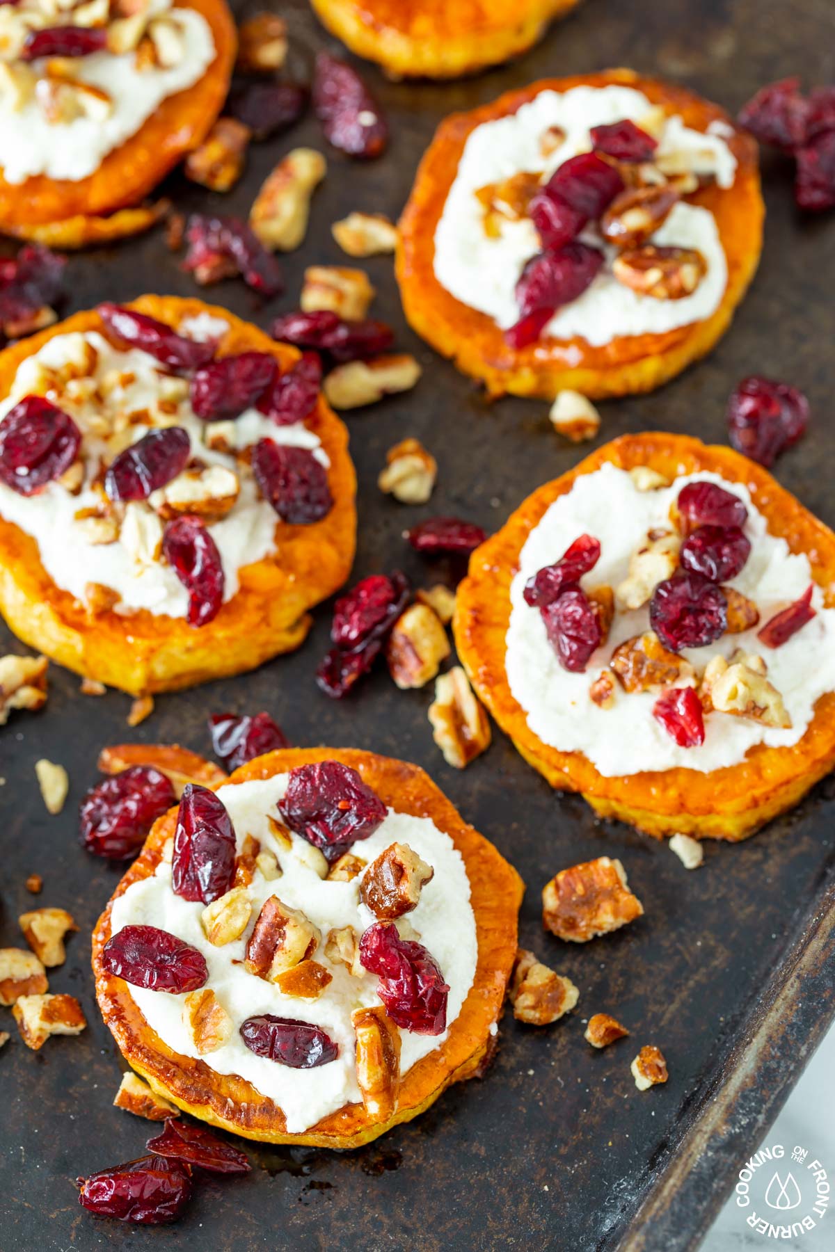 sweet round rounds on a sheet topped with goat cheese pecans dried cranberries