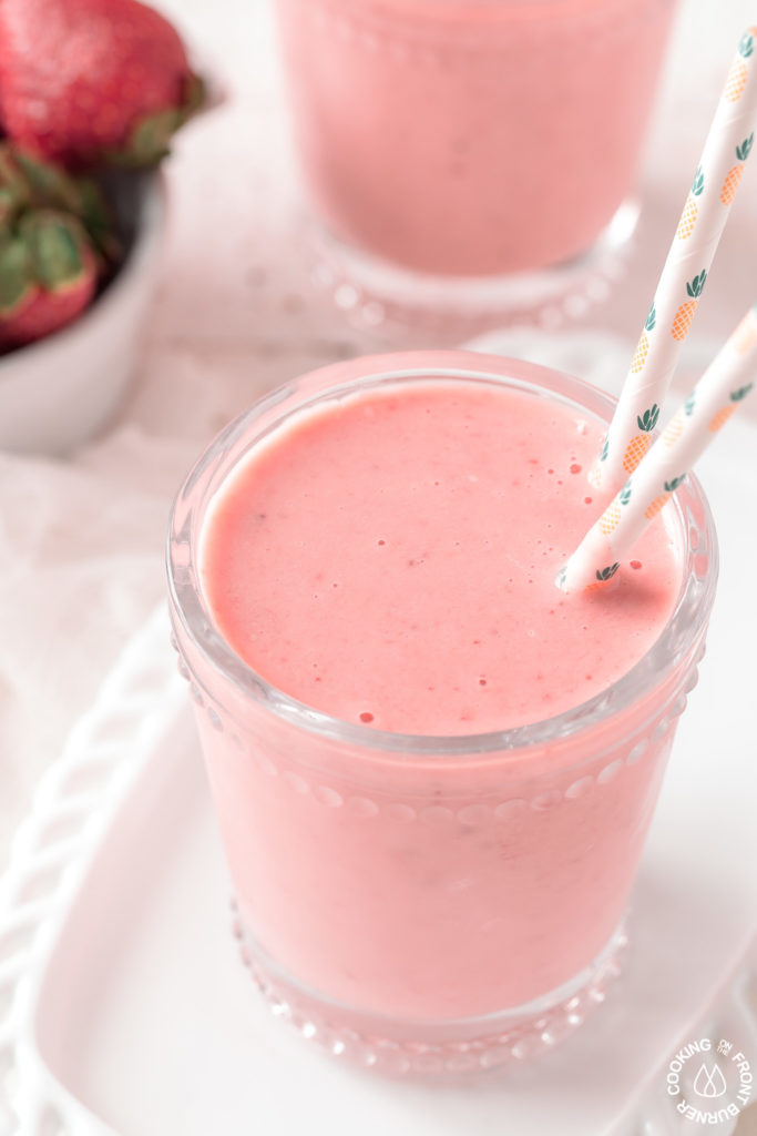 a smoothie in a glass with straws
