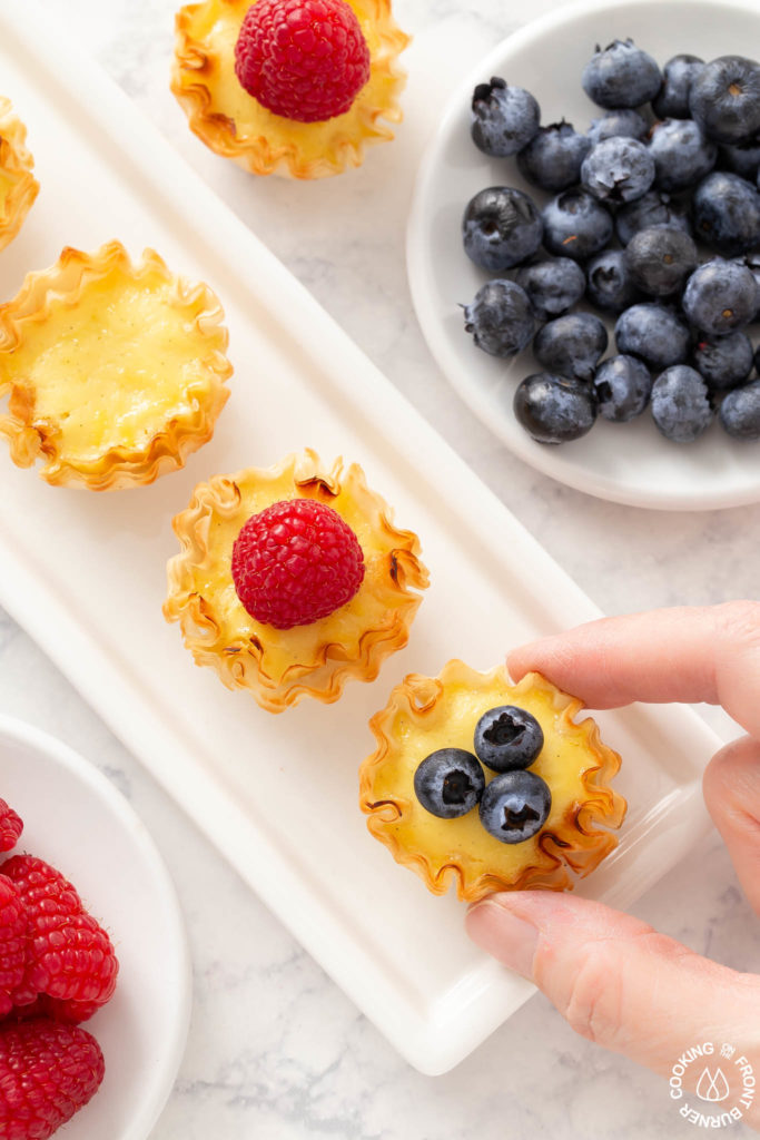 taking a lemon tart off a plate