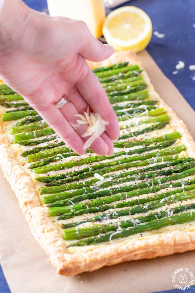 parmesan cheese sprinkled on an asparagus tart