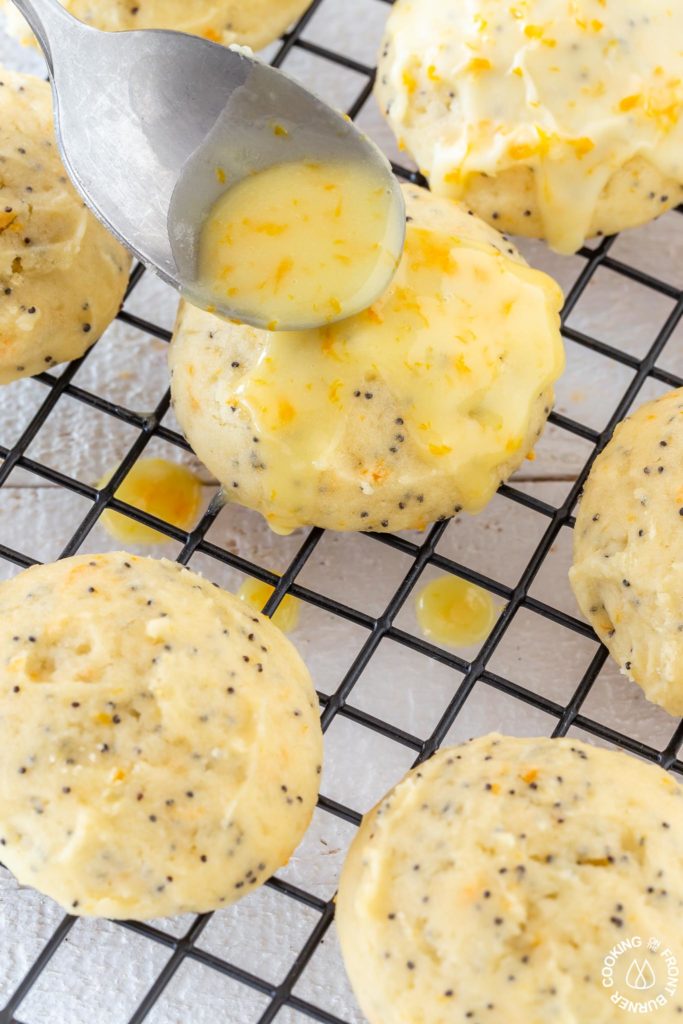 pouring glaze on a ricotta poppy seed cookie