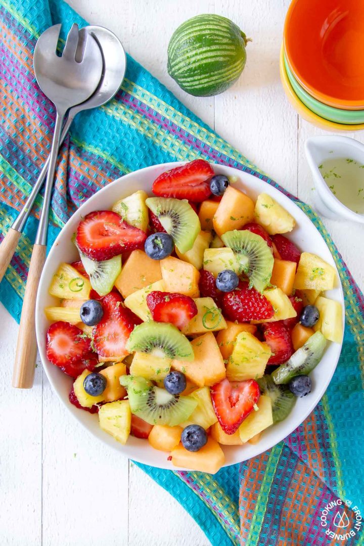 a round white bowl with fresh fruit and a tequila simple syrup