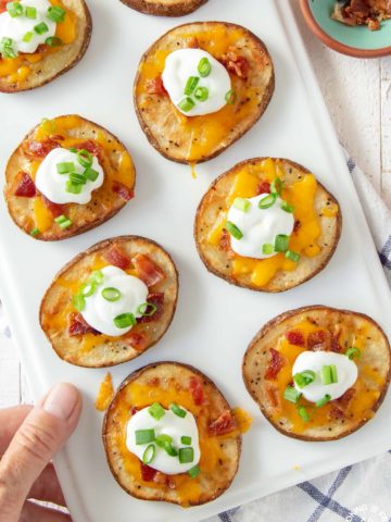 loaded baked potato rounds on a platter