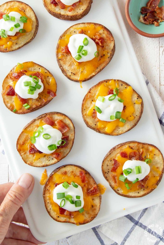 loaded baked potato rounds on a platter