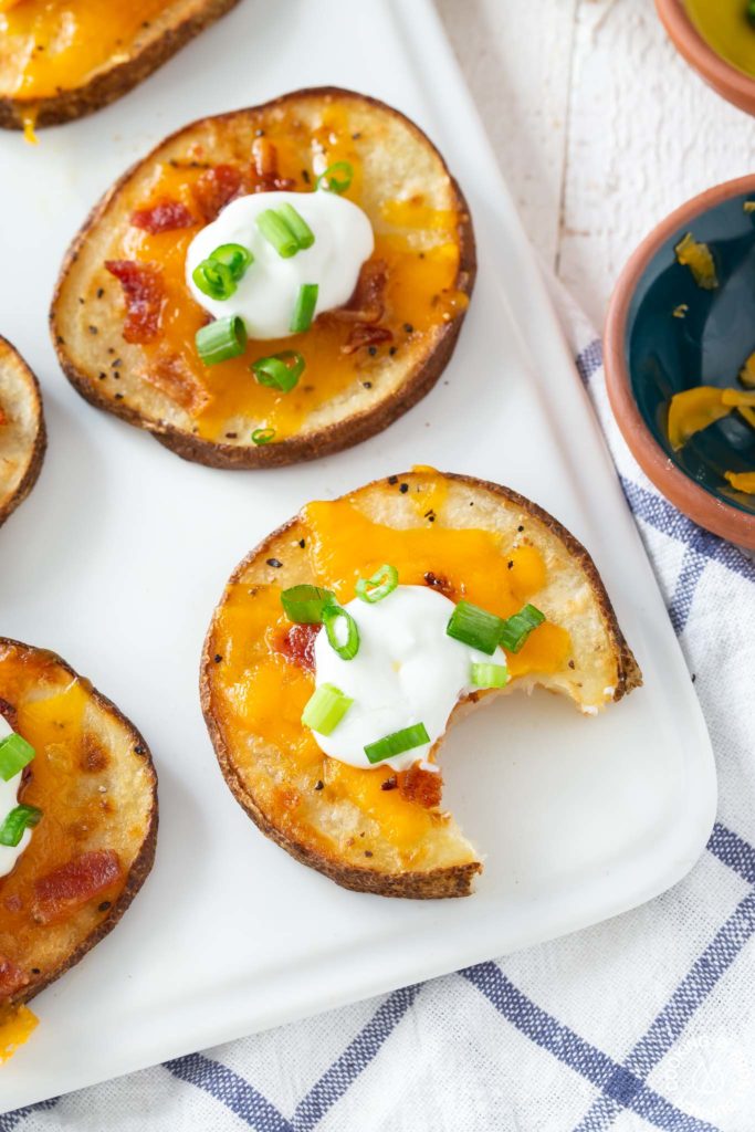 loaded potato round on a platter with a bite taken out of it