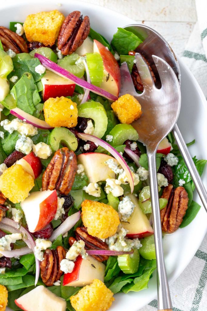 close up of spinach apple salad in a bowl