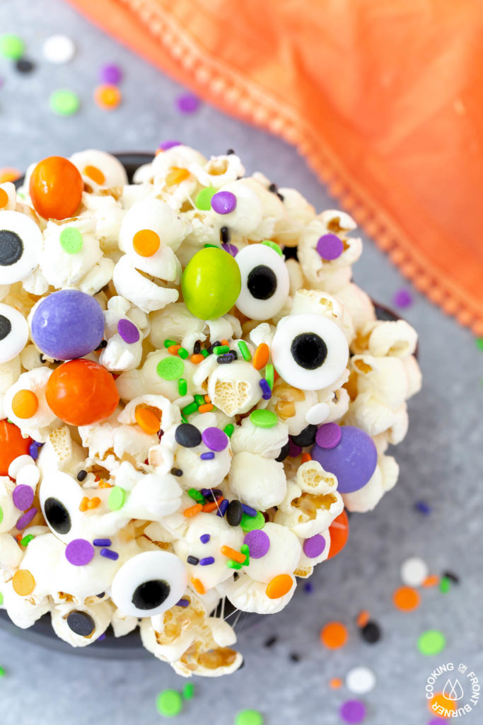 a close shot of a bowl of halloween snack mix