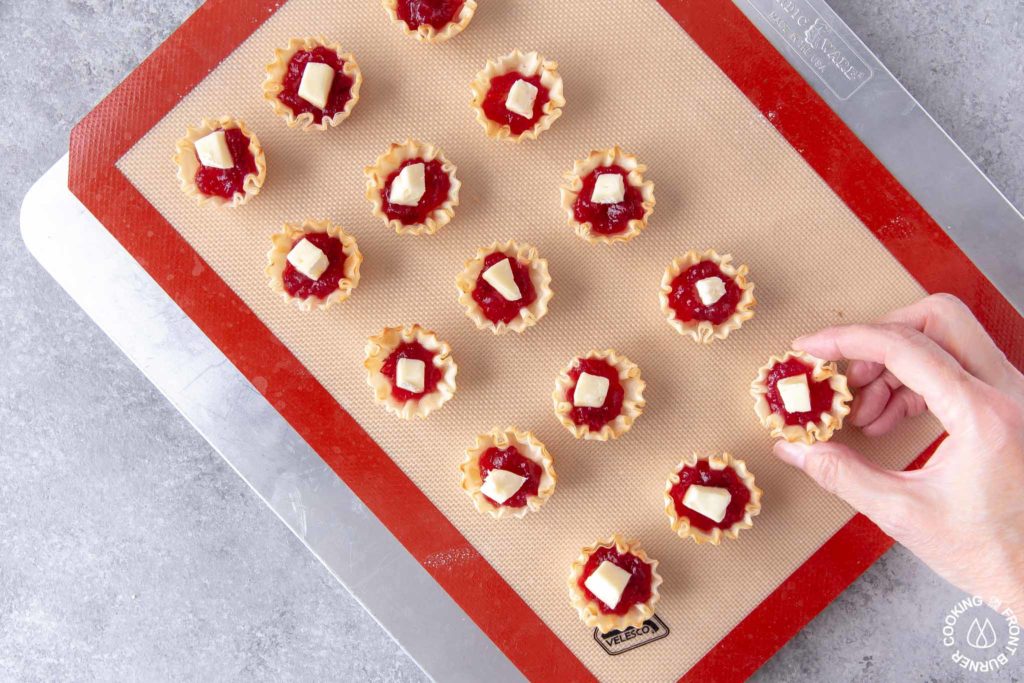 unbaked tarts on a cookie sheet 