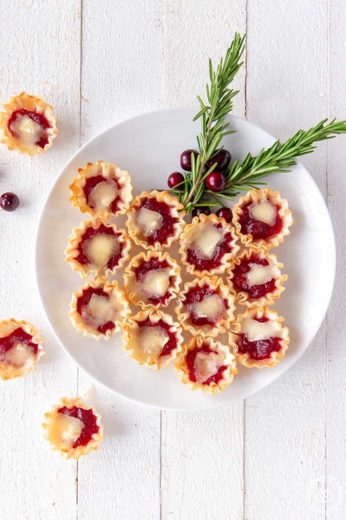 cranberry orange brie tarts on a plate