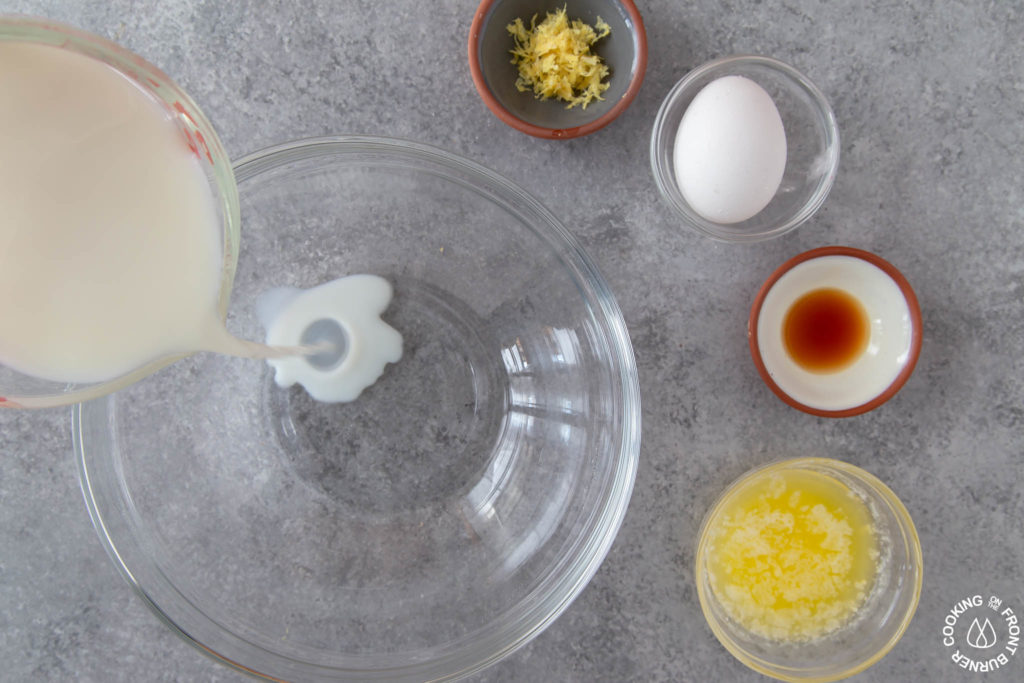 pouring milk into a bowl to make mini pancakes