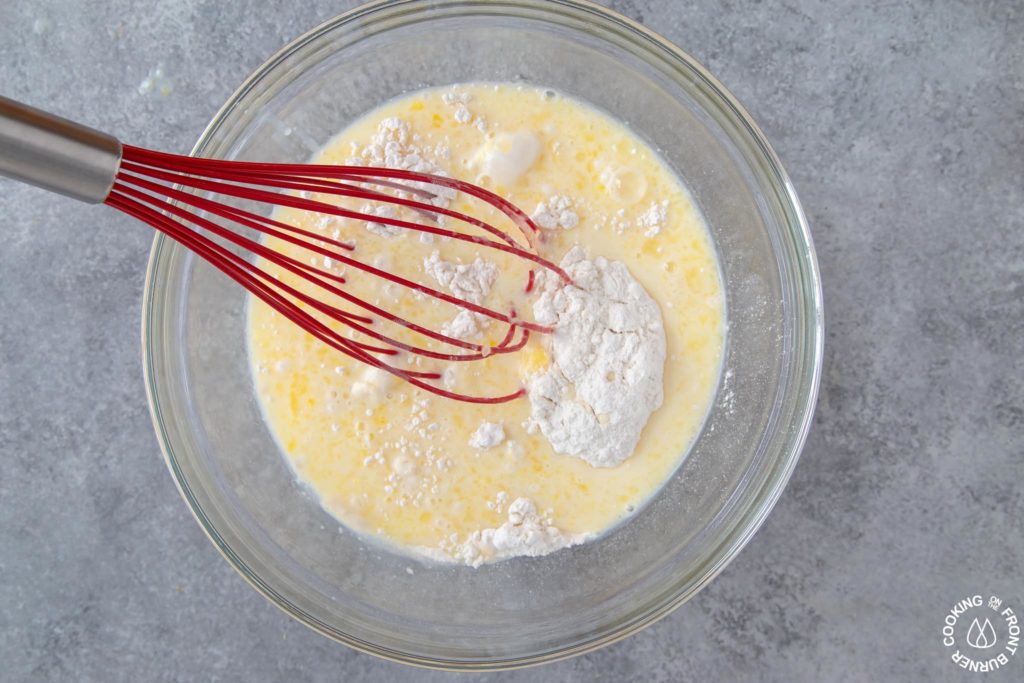 whisking together wet and dry pancake ingredients