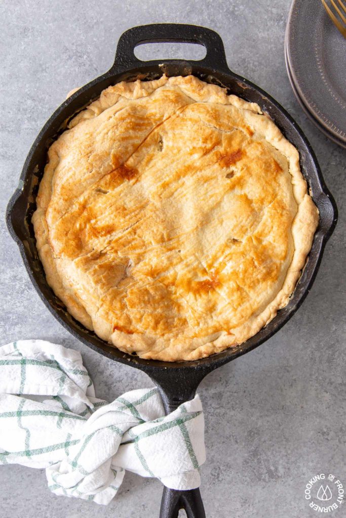 a baked chicken pot pie in a cast iron skillet