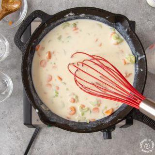 stirring spices into a skillet for chicken pot pie