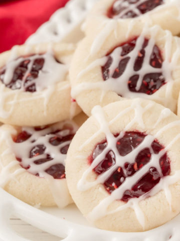 a plate of raspberry thumbprint cookies