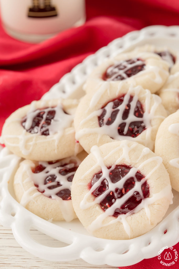 raspberry thumbprint cookies on a cookie tray