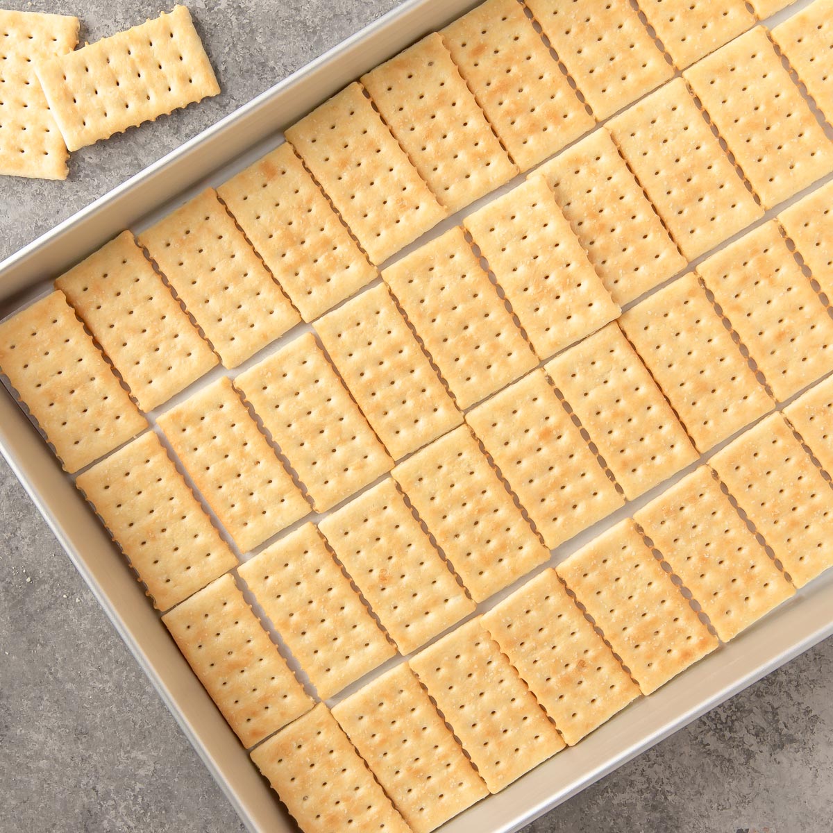 a jelly roll pan lined with crackers