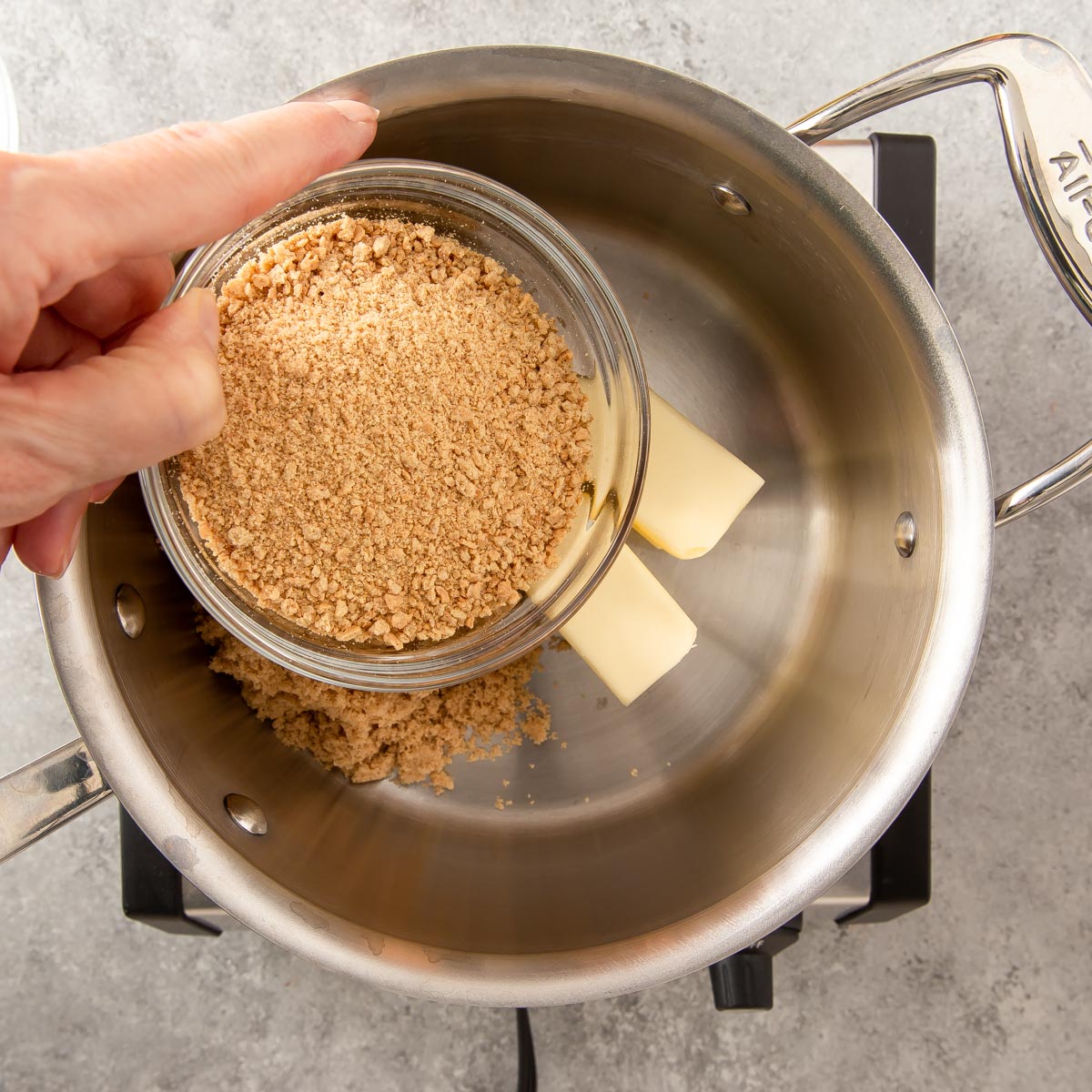 adding ingredients in a pan making toffee bars