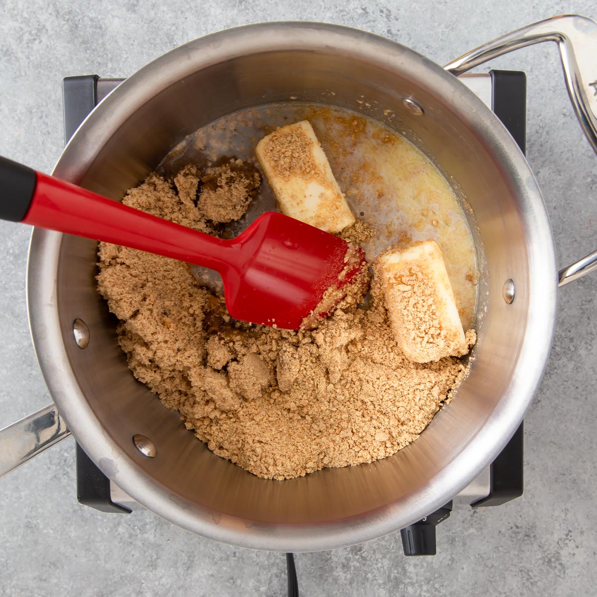 stirring ingredients in a pan for toffee bars