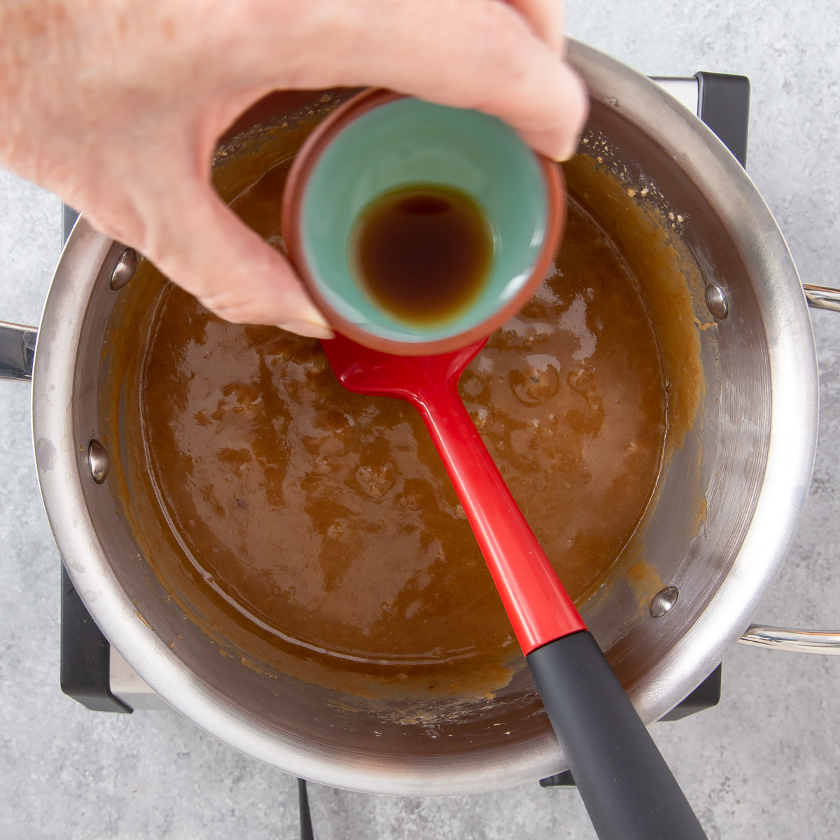 adding vanilla in a pan with cooked toffee mixture