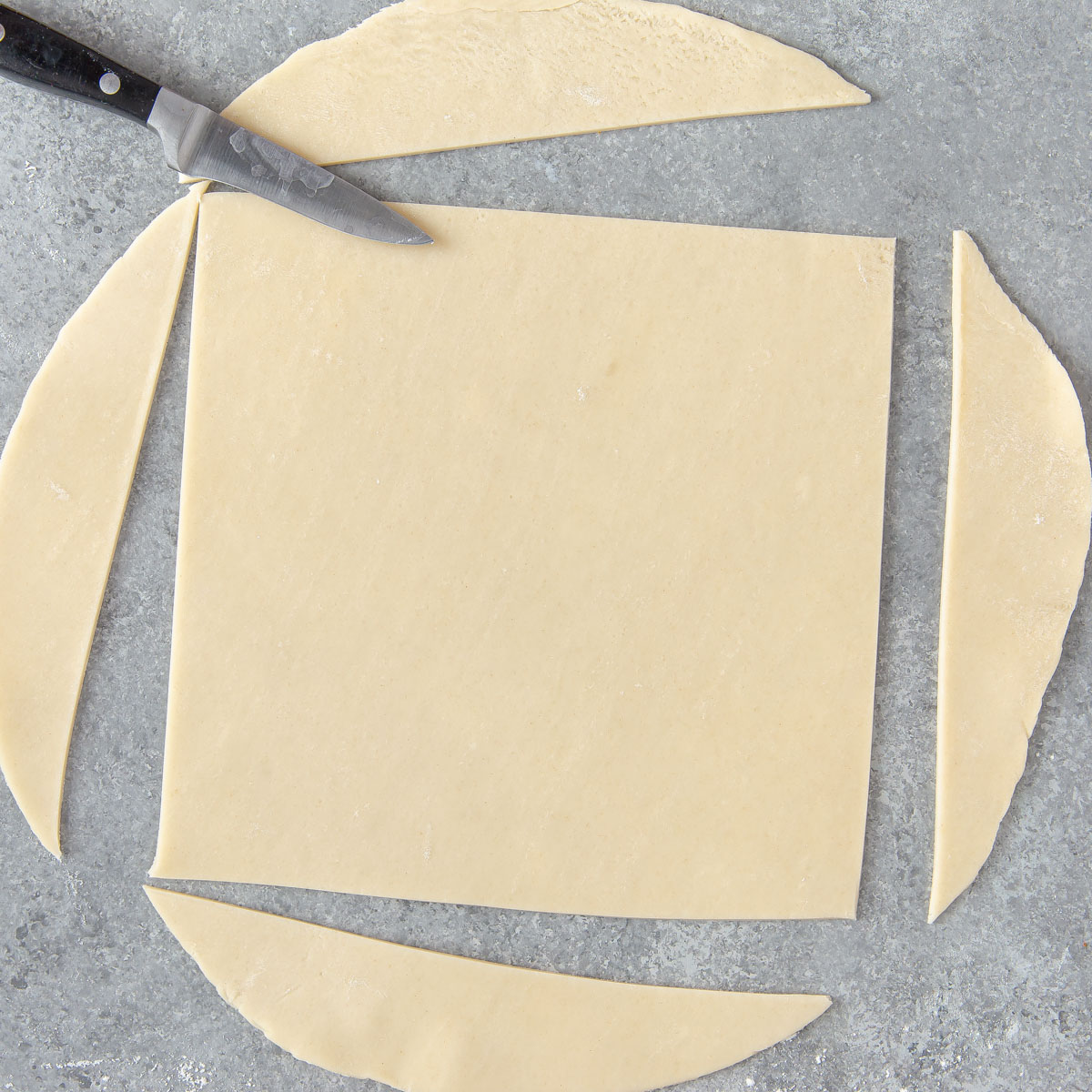 cutting a round pie crust into a square