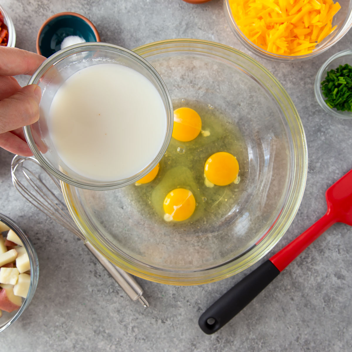 a bowl with eggs adding in milk
