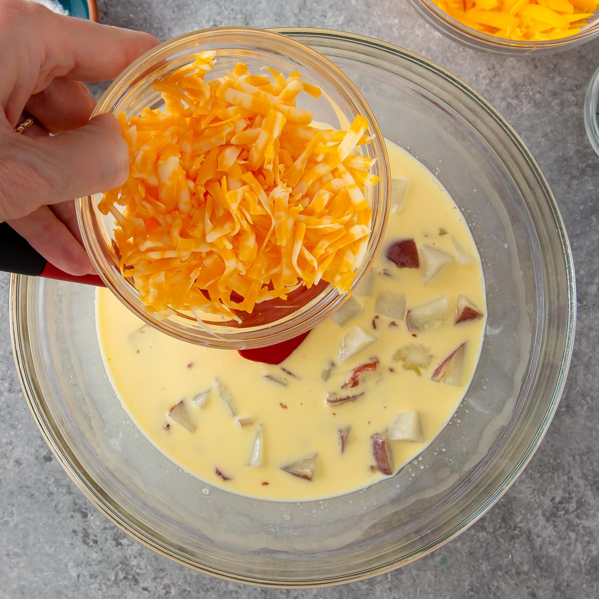 adding monterey jack cheese to quiche mixture