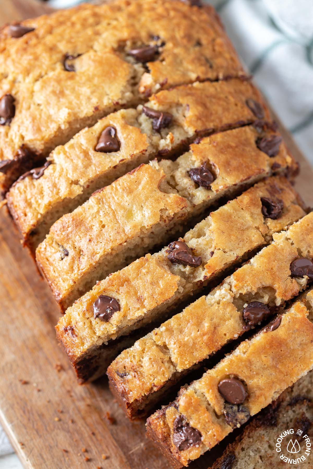 chocolate chip banana bread cut into slices on a board