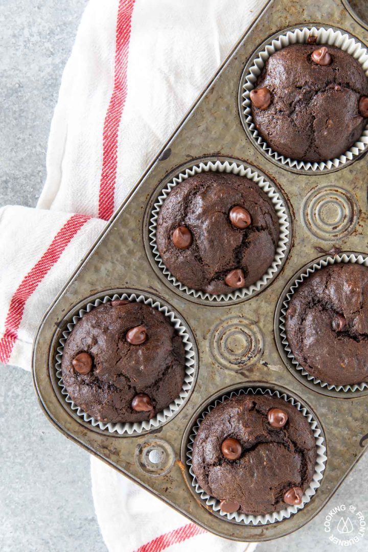 chocolate chip banana muffins in a muffin tin