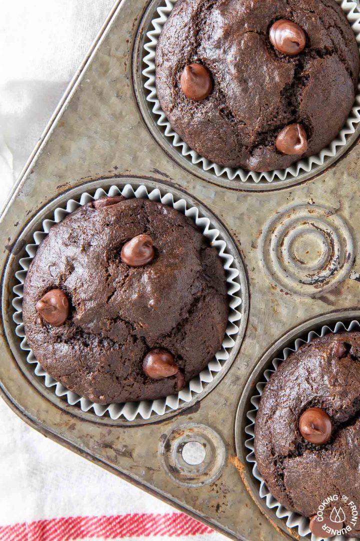 a close up of a chocolate chip banana muffin in a muffin tin