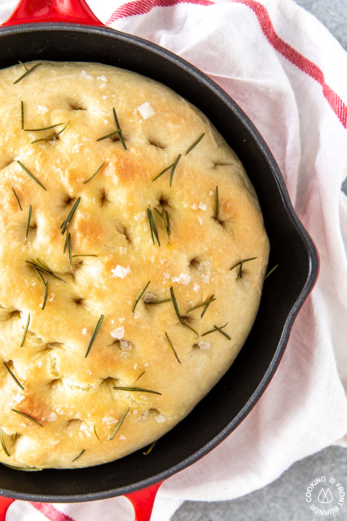 a close up shot of rosemary focaccia bread in a skillet