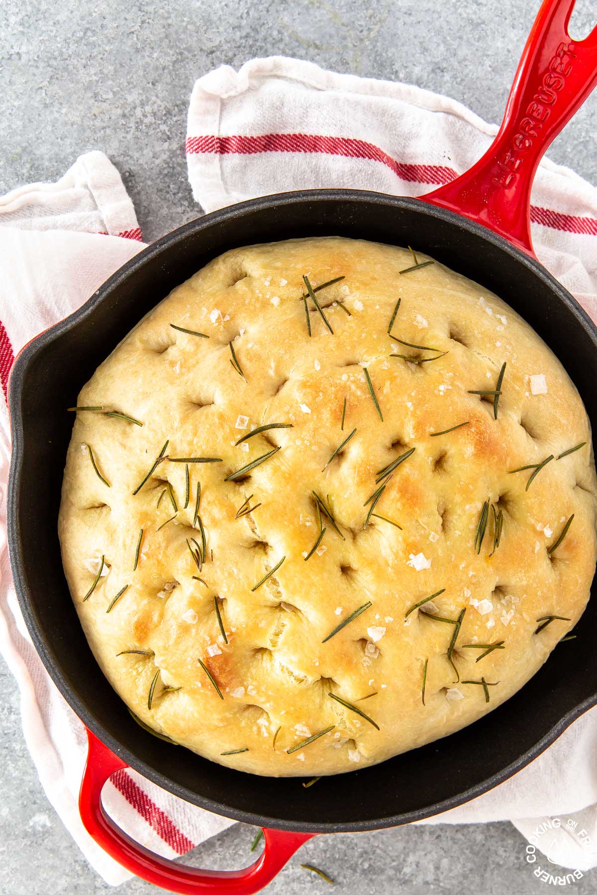 a skillet with baked focaccia bread 