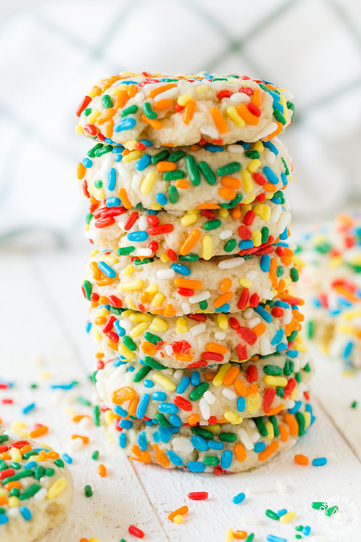 a stack of sprinkle cookies on a board