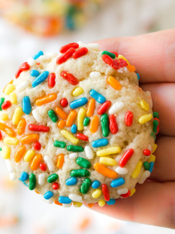 a chewy sprinkle cookie in a hand
