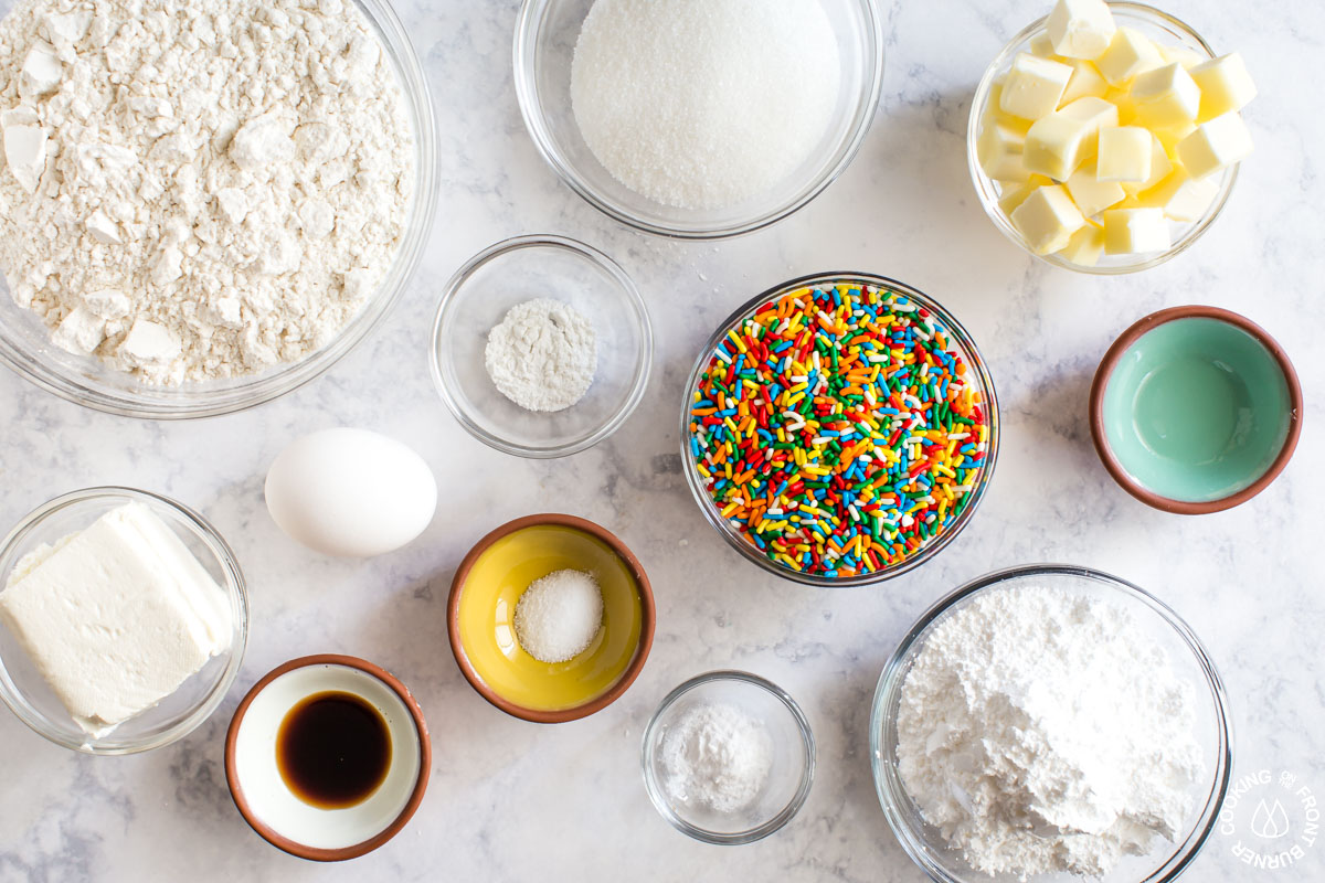 a table with all the ingredients needed for sprinkle cookies