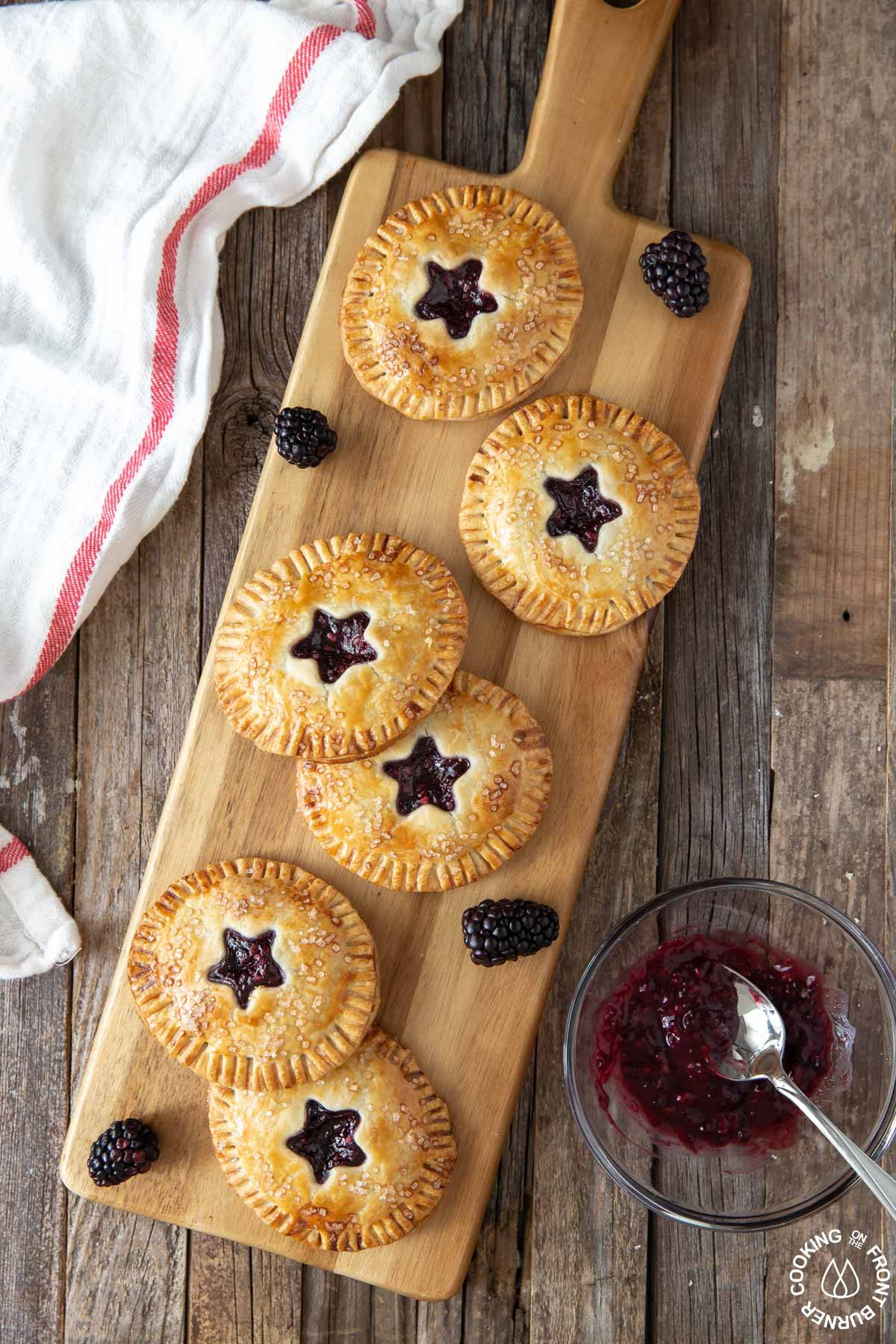 6 blackberry hand pies on a serving board