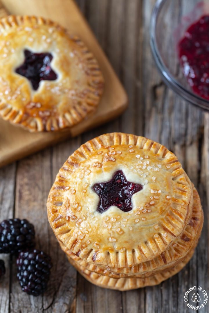 3 hand pies stacked on a board 