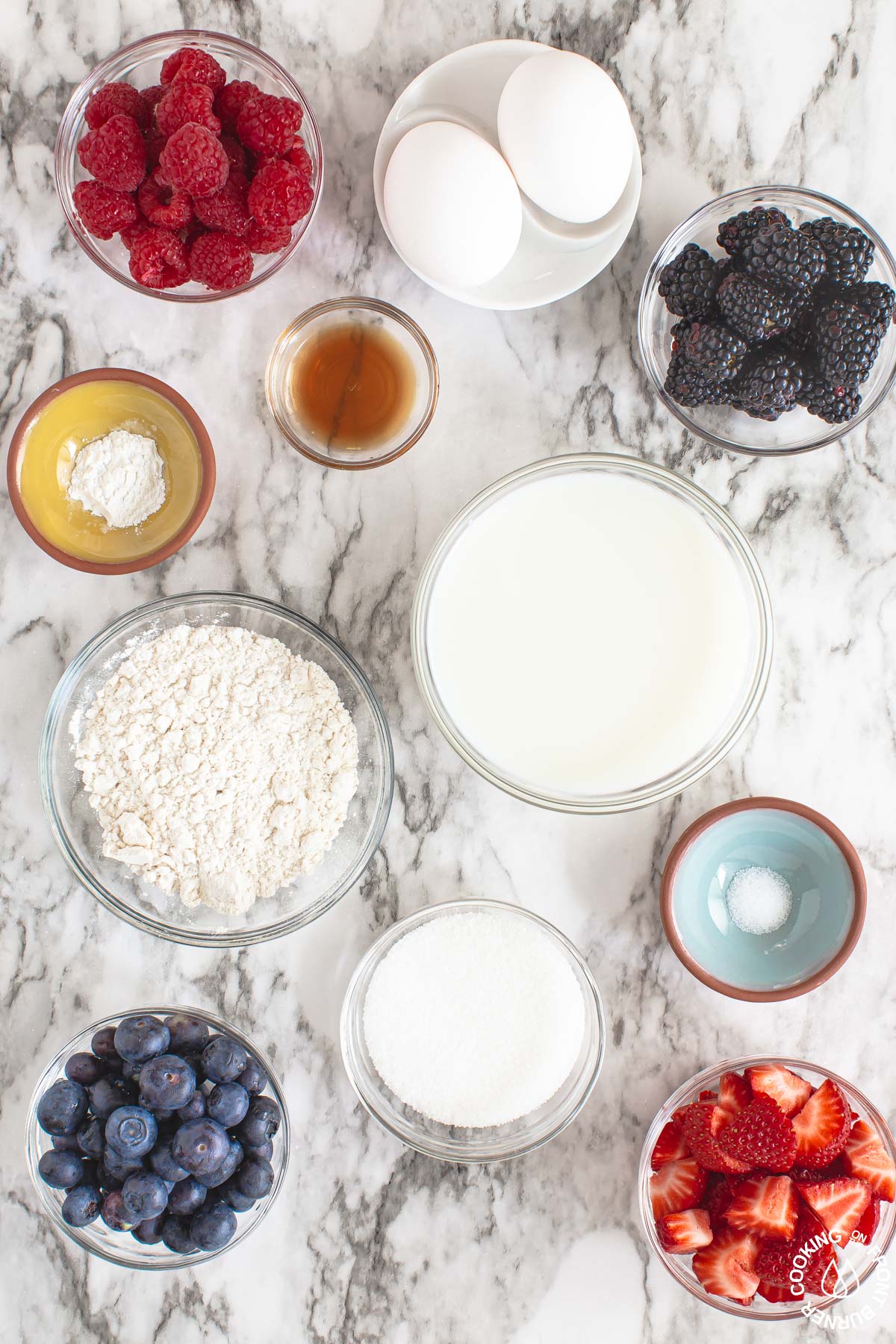 a board with ingredients needed to make a berry dessert