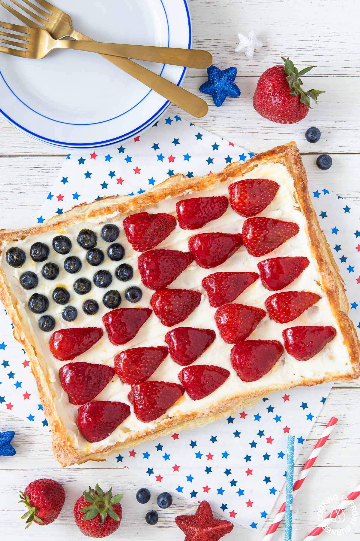 a puff pastry tart with berries arranged into an american flag