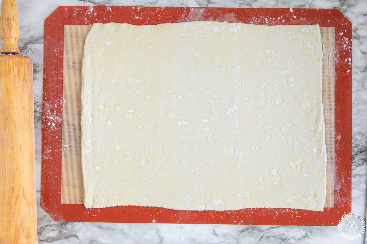 a sheet of thawed puff pastry on a silpat mat rolled in a 10x12" shape