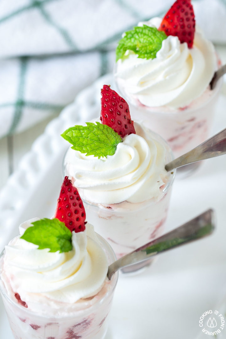 strawberry shooters on a plate with spoons