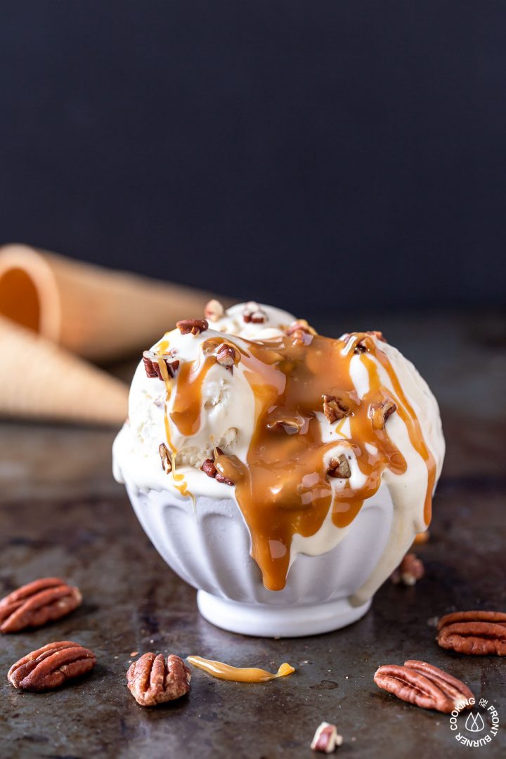 a  bowl of no churn bourbon pecan caramel ice cream melting in a bowl